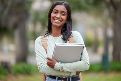 student girl holding a notebook