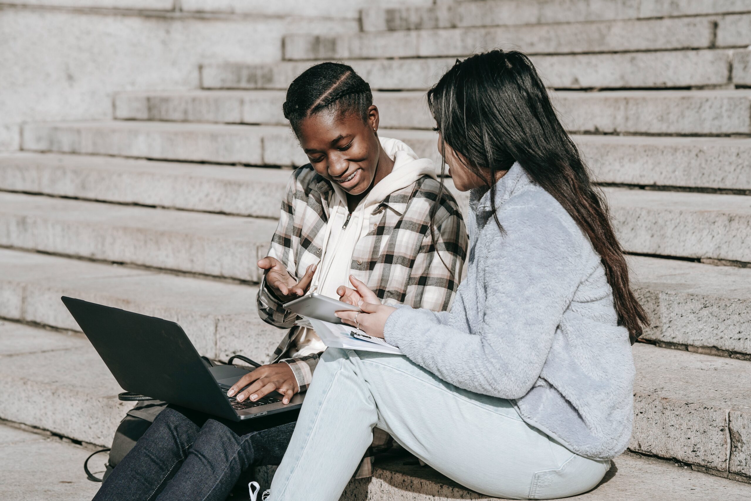 two girl sitting on stairs
