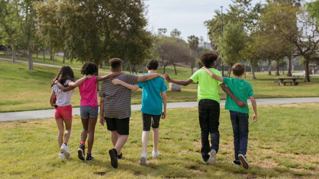 children hugging in park