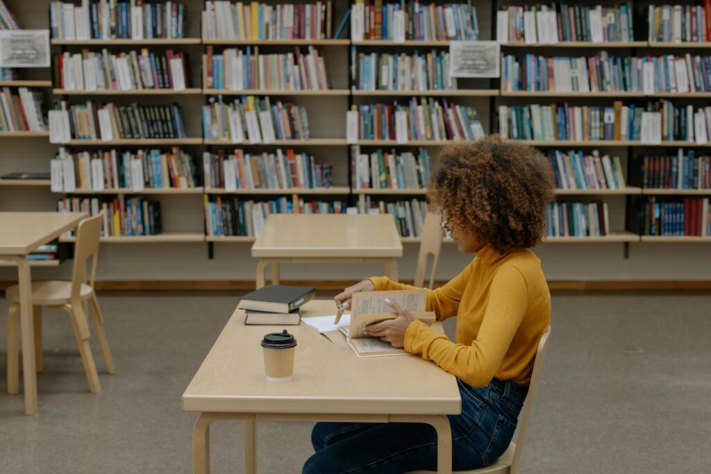 girl reading a book at the library