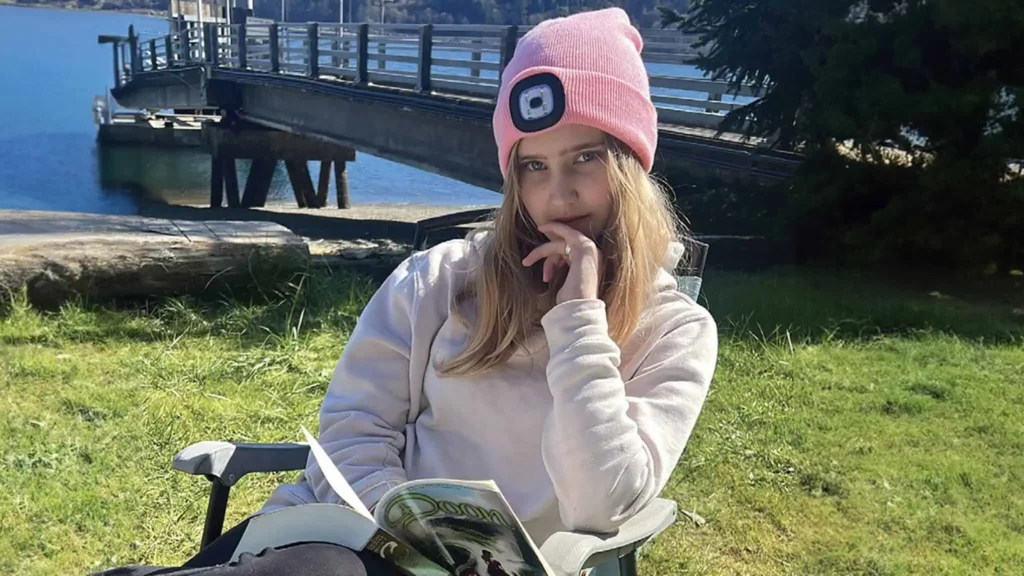 girl reading a book in the river