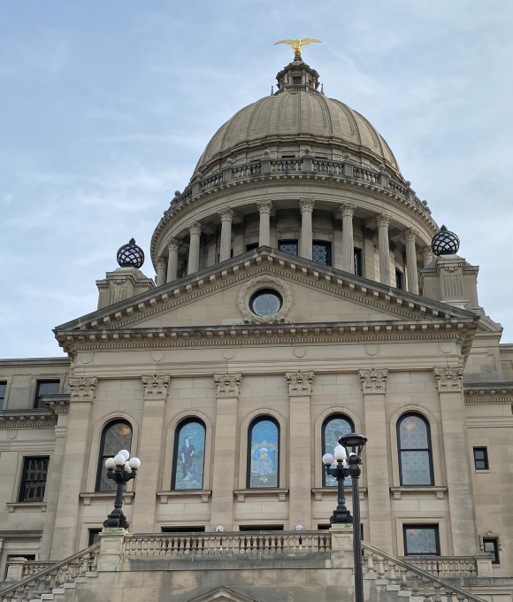 The Missouri Capitol building, an iconic structure, stands majestically against a clear blue sky, showcasing its grand architecture.