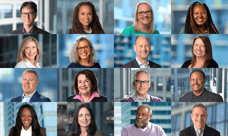 A diverse group of sixteen people arranged in a four-by-four grid, each person smiling against a blurred office background, conveying professionalism and warmth.