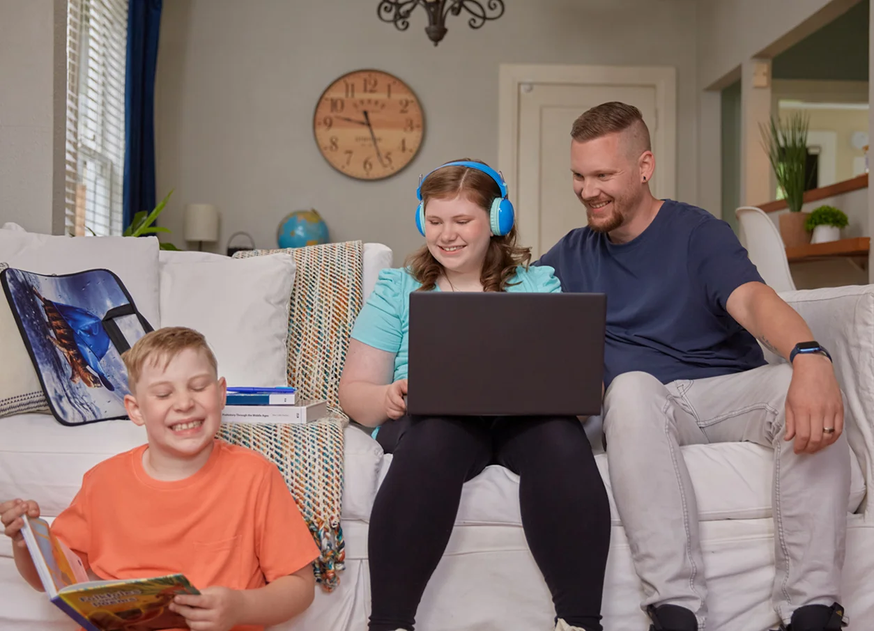 Father and his children working together with their laptops at home